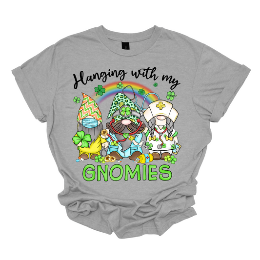 ☘️ "Hanging with my Gnomies" St. Patrick's Day T-shirt: A Tribute to Healthcare Heroes! ☘️  Get into the St. Patrick's Day spirit with our heartwarming and whimsical tee featuring three charming gnomes dressed in healthcare worker apparel, complete with stethoscopes. It's a delightful fusion of Irish cheer and appreciation for the incredible work of our healthcare heroes. Shop at Gorgeousware.com today!