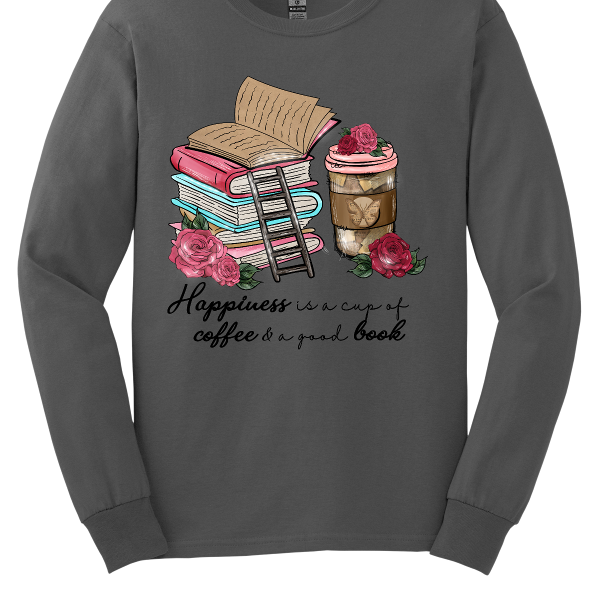 "Happiness is a cup of coffee and a good book" A delightful and cozy garment that celebrates the simple joys of life. This shirt is a perfect ode to those blissful moments when you can unwind with the warmth of a cup of coffee in hand and the company of a captivating book.  The design features a charming depiction of a steaming cup of coffee paired with an open book, creating a visual representation of the tranquil happiness that comes from this comforting combination. Shop at Gorgeousware.com