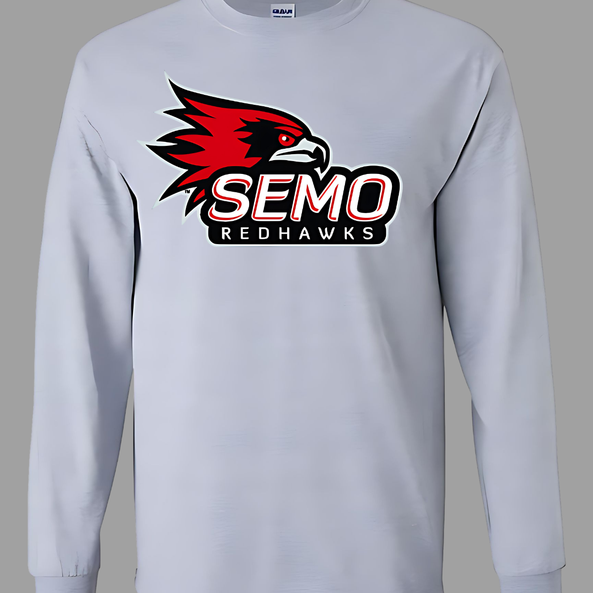 This vibrant t-shirt features the iconic SEMO Redhawk logo prominently displayed at the top, showcasing the fierce spirit of the team. Below the hawk, bold bubble letters spell out "SEMO," creating a playful and eye-catching design. Just underneath, in smaller, stylish print, the word "Redhawks" completes the look, making it a perfect blend of fun and team pride.  Shop at Gorgeousware.com