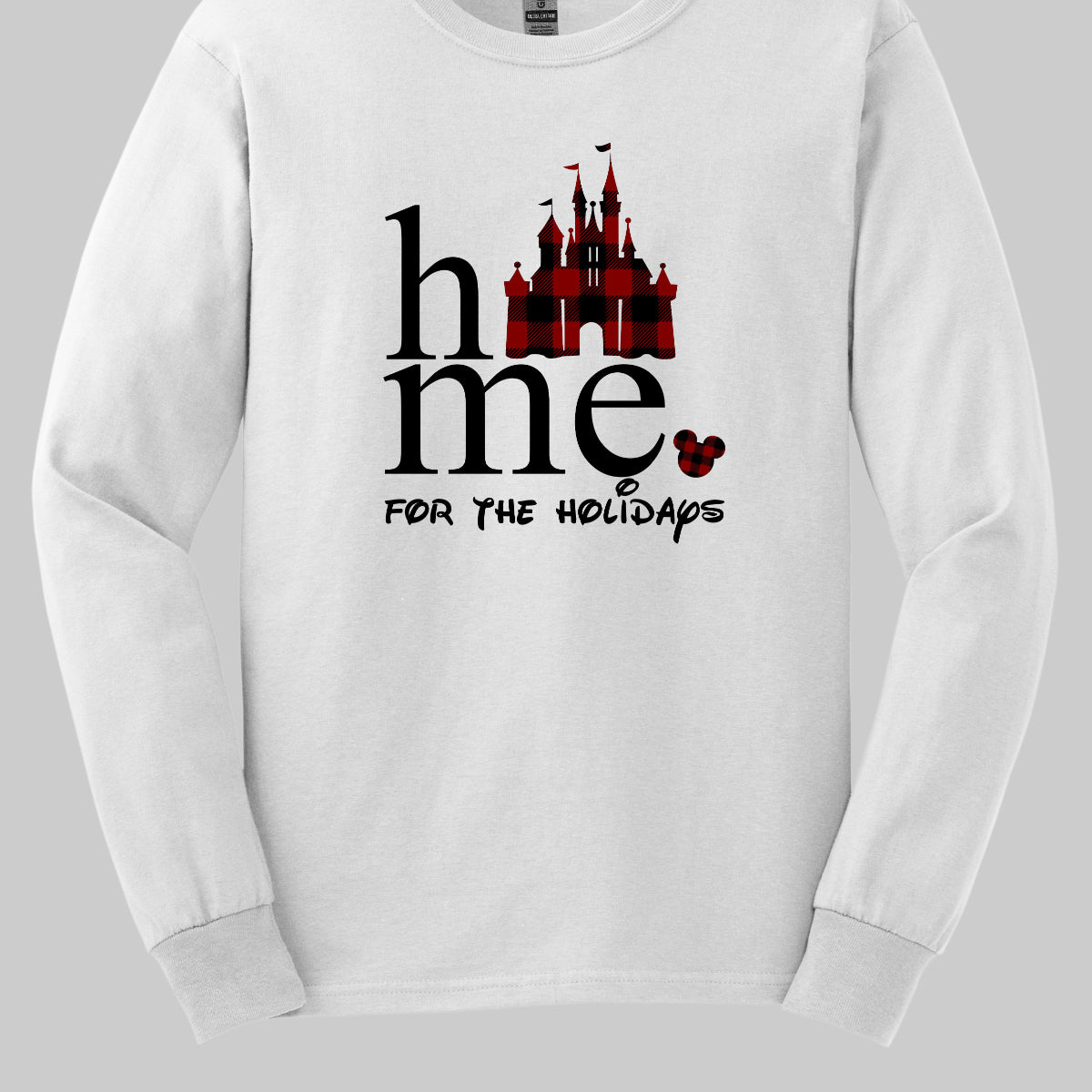 The t-shirt features the festive phrase "Home for the Holidays" with a delightful and whimsical touch. The word "Home" is showcased in a bold, playful font. In place of the "O" in "Home," there is a charming red and black checkerboard princess castle, adding a magical and eye-catching element to the design. Shop Gorgeousware.com