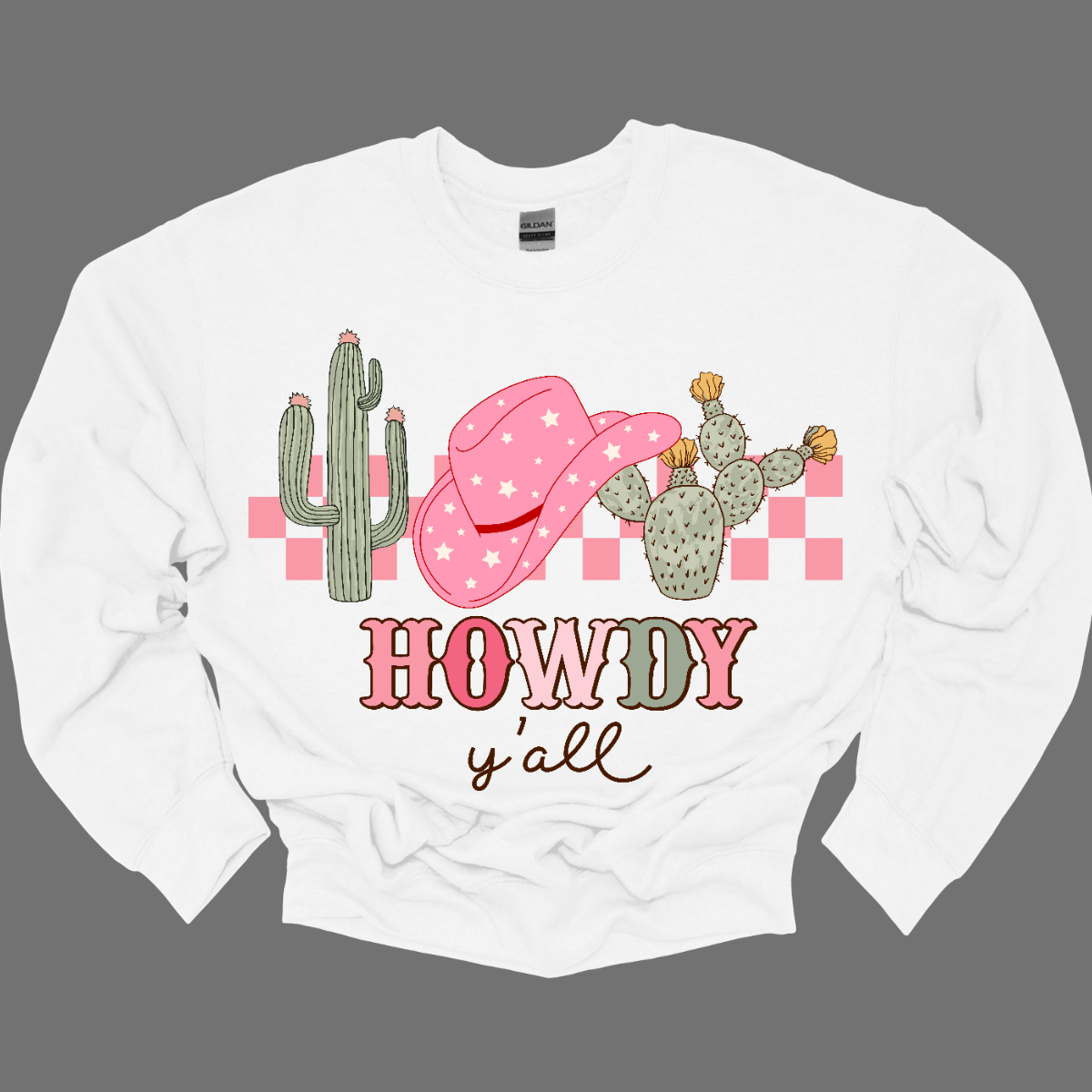 Introducing our "Howdy Ya'll" T-shirt – a spirited and charming garment that welcomes everyone with a touch of Southern hospitality. This shirt features a delightful design adorned with cactuses and a stylish cowgirl hat, creating a perfect blend of country Western flair and friendly greetings. The cactuses add a touch of desert charm, while the cowgirl hat brings a stylish and playful element to the overall design. Shop at Gorgeousware.com