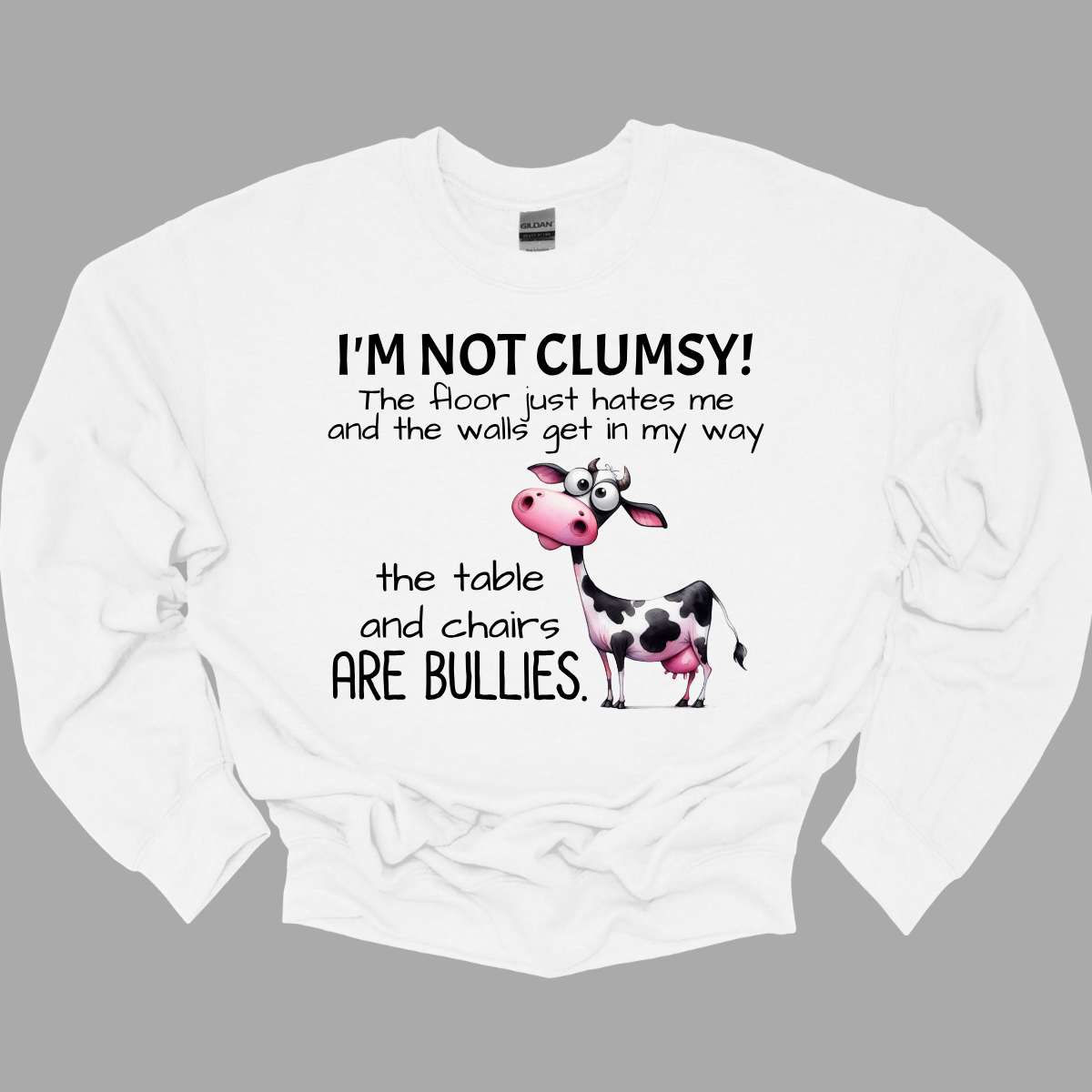 Ever feel like the universe is out to get you? With our “I’m not clumsy! The floor just hates me, and the walls get in my way, the tables and chairs are bullies” t-shirt, you can wear your battle scars with pride! Featuring a cheeky bull design, this shirt is perfect for anyone who’s had their fair share of run-ins with furniture and flooring. Shop at Gorgeousware.com