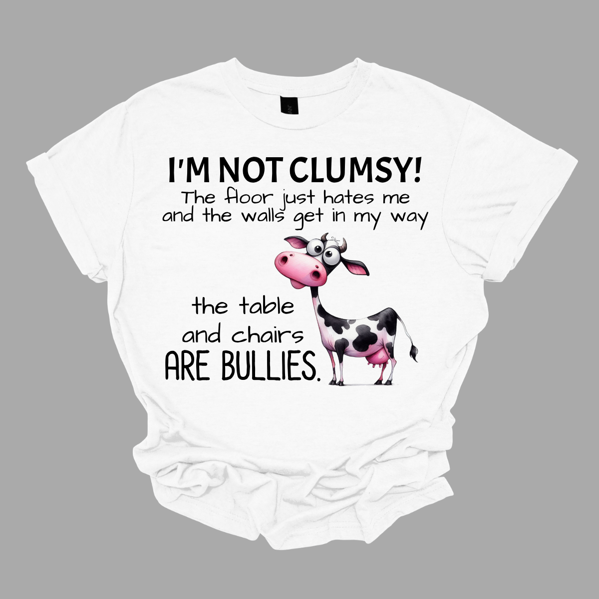 Ever feel like the universe is out to get you? With our “I’m not clumsy! The floor just hates me, and the walls get in my way, the tables and chairs are bullies” t-shirt, you can wear your battle scars with pride! Featuring a cheeky bull design, this shirt is perfect for anyone who’s had their fair share of run-ins with furniture and flooring. Shop at Gorgeousware.com