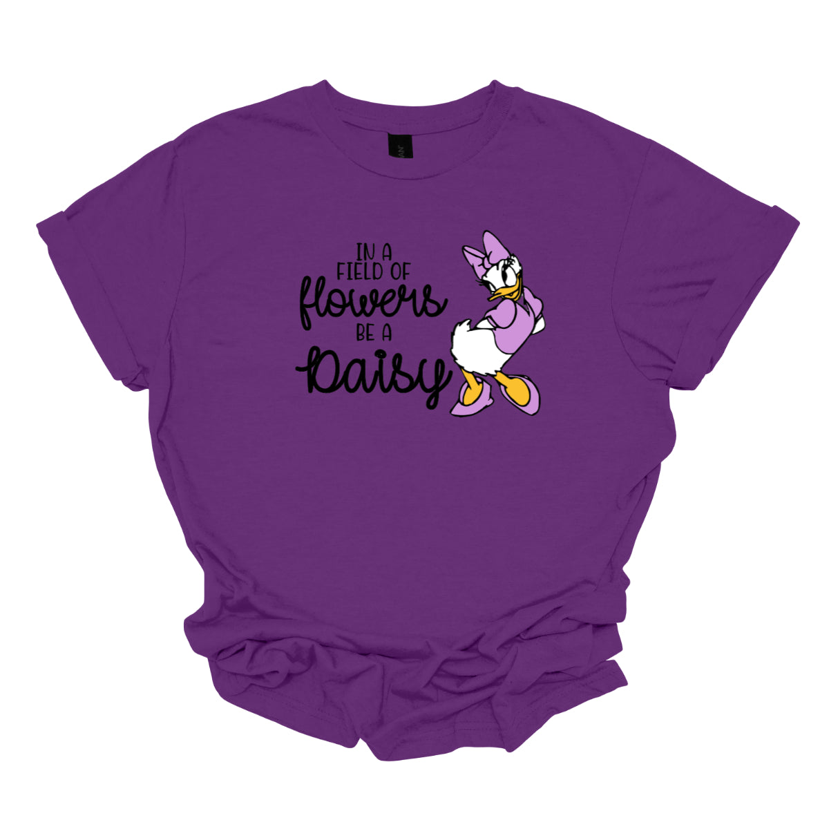 This t-shirt features an inspiring and charming design with the uplifting message: "In a Field of Flowers Be a Daisy." The phrase is styled with a delightful mix of fonts. The words "In a Field of" and "Be a" are written in a playful black font, bringing a touch of fun to the overall look. The words "Flowers" and "Daisy" are highlighted in a graceful black cursive font, adding a touch of elegance and flow. Next to the text, there’s a cute illustration of the cartoon character Daisy. Shop Gorgeousware.com