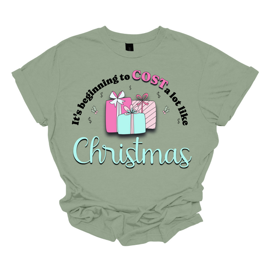 Celebrate the season with a playful twist on holiday spending! Our “It’s Beginning to COST a Lot Like Christmas” T-shirt is perfect for those who know the holiday cheer comes with a bit of financial cheer too. Embrace the holiday hustle with a grin and a reminder that Christmas is priceless—even if it costs a bit! Shop at Gorgeousware.com