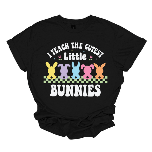 Show off your love for teaching with our 'I teach the cutest little bunnies' T-shirt! Adorned with five adorable pastel bunnies sitting in a row, this shirt is a sweet celebration of the precious students who fill your classroom. Shop now at Gorgeousware.com