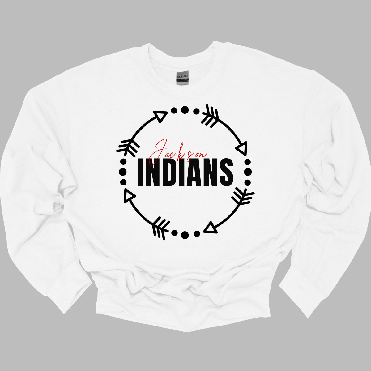 The T-shirt design features a dynamic and spirited look with a white arrow circle at its center. This circle encircles the words "Jackson" and "Indians" in a striking color scheme highlighting school pride. The arrow circle adds a sense of movement and energy, making the overall design both modern and eye-catching. This T-shirt is perfect for showcasing school spirit with style. Shop at gorgeousware.com