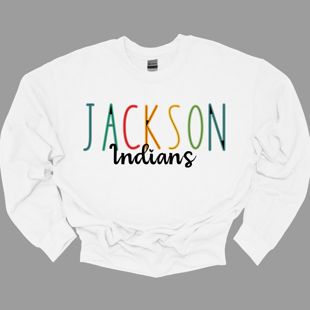 Show your Jackson pride with our vibrant Jackson Indians Spiritwear T-shirt! This eye-catching design features "Jackson" prominently highlighted in a spectrum of bold, dynamic colors, showcasing your school spirit in every shade. The word "Indians" is elegantly scripted in black cursive, adding a touch of classic sophistication to this spirited tee.  Shop at Gorgeousware.com