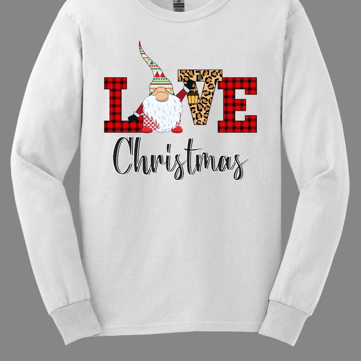 This charming t-shirt showcases the word "LOVE" in a festive and fun design. The letters "L" and "E" are styled in a classic red buffalo plaid, adding a cozy, rustic touch. The "V" pops with a bold cheetah print, bringing an unexpected and trendy flair to the design. The "O" is replaced by an adorable gnome, whose whimsical hat features a cheerful ugly sweater Christmas pattern in vibrant red, green, and white. Shop at Gorgeousware.com