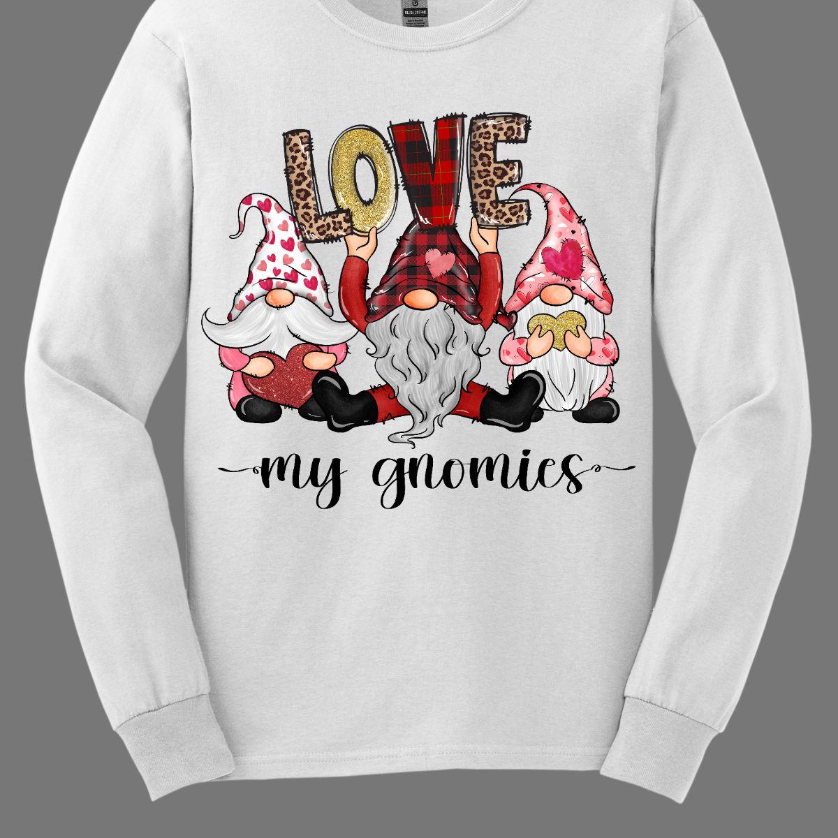 Introducing our "Love My Gnomies" T-shirt – a heartwarming and whimsical garment that celebrates the joy of friendship with three adorable gnomes holding up the word "love." This shirt is a delightful expression of love and camaraderie perfect for Valentine's Day. The design features three adorable gnomes, holding up the word "love," creating a cute and charming scene. Shop at Gorgeousware.com