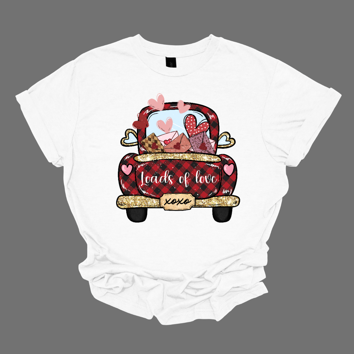 Introducing our "Loads of Love" T-shirt – a heartwarming and charming garment that combines the rustic charm of a red and black plaid pickup truck with a generous load of love letters and hearts. This shirt features the back end of a pickup truck filled to the brim with sentiments of love. The truck bed is overflowing with an abundance of love letters, each sealed with care, and accompanied by whimsical hearts. Shop at Gorgeousware.com