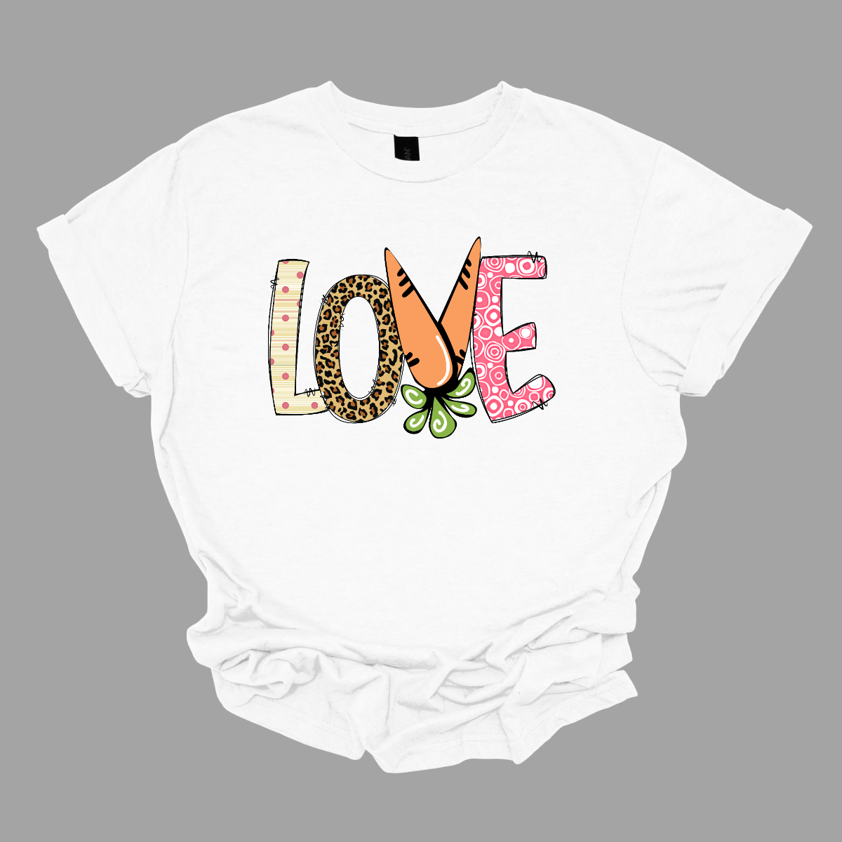 Get ready to celebrate Easter in style with our vibrant 'love' T-shirt! Each letter is adorned with a different spring pattern, capturing the essence of the season's beauty and renewal. But it's the 'V' that steals the show, cleverly crafted as two carrots, symbolizing growth and abundance. This shirt is a playful homage to Easter traditions, blending elements of nature with the warmth of love. Shop at Gorgeousware.com