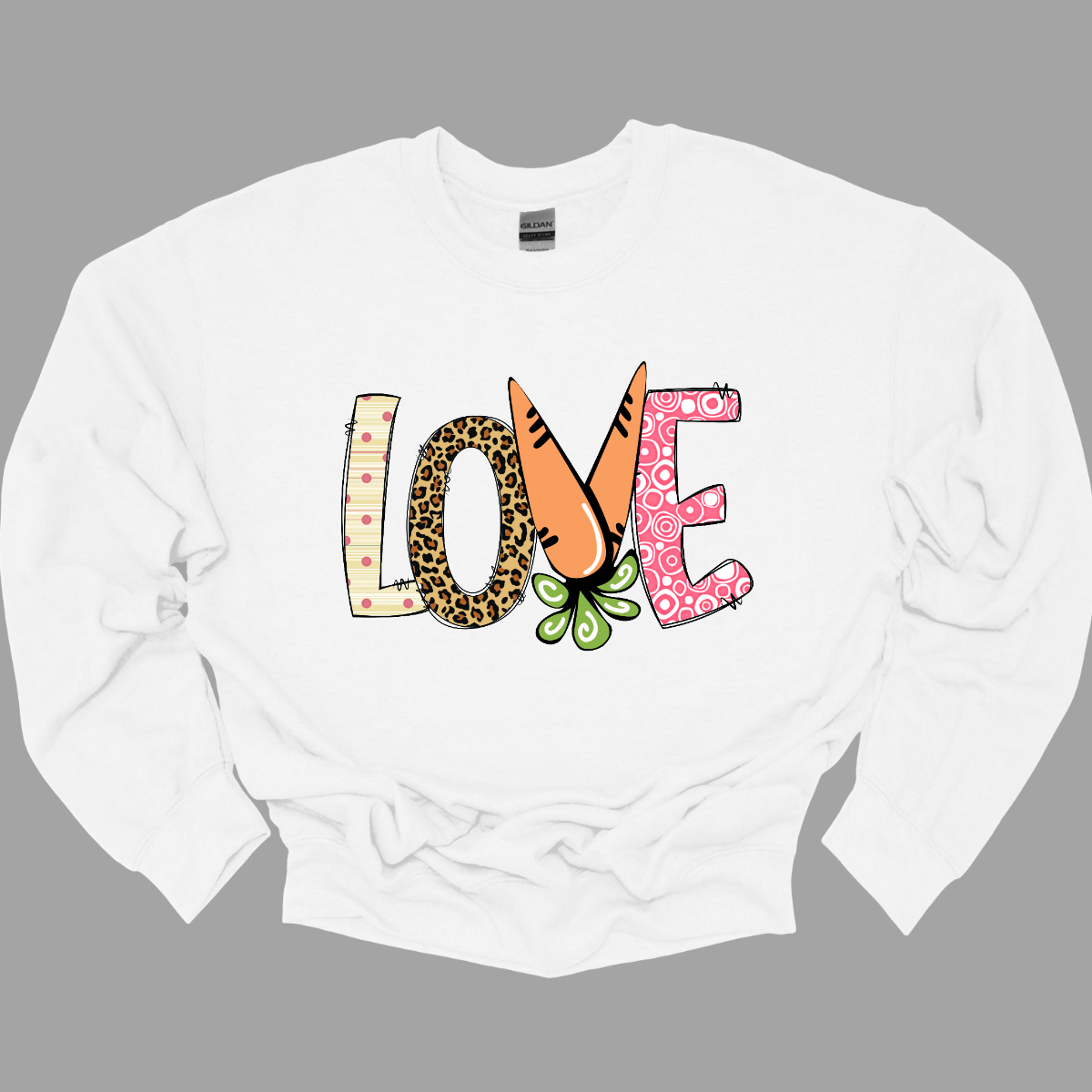 Get ready to celebrate Easter in style with our vibrant 'love' T-shirt! Each letter is adorned with a different spring pattern, capturing the essence of the season's beauty and renewal. But it's the 'V' that steals the show, cleverly crafted as two carrots, symbolizing growth and abundance. This shirt is a playful homage to Easter traditions, blending elements of nature with the warmth of love. Shop at Gorgeousware.com