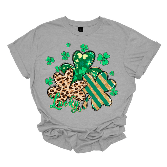 Embrace the luck of the Irish with our spirited St. Patrick's Day shirt featuring a playful twist! Our 'Lucky' shirt boasts a lively pattern of classic shamrocks, including a bold cheetah print shamrock for a touch of wild charm. Shop at Gorgeousware.com