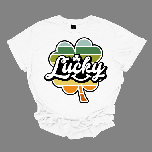 Introducing our "Lucky with Retro Color Striped Shamrock" T-shirt, a vibrant and stylish addition to your wardrobe! This eye-catching design features a bold shamrock in retro-inspired colors, set against the word "lucky" in a playful font. Shop at Gorgeousware.com