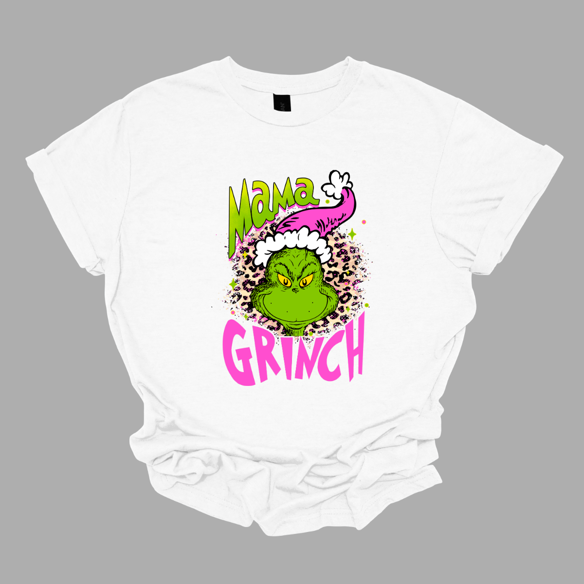 At the center of the design is the phrase "Mama Grinch," rendered in a whimsical, Grinch-style font. The word "Mama" pops in a vibrant green color with a delicate pink shadow that adds a touch of charm. The word "Grinch" contrasts in a bold, eye-catching pink that stands out against the green.&nbsp;Between the two words, there's a delightful illustration of the Grinch himself. He's sporting a cute pink and white Santa hat, which adds a fun and seasonal flair. Shop Gorgeousware.com