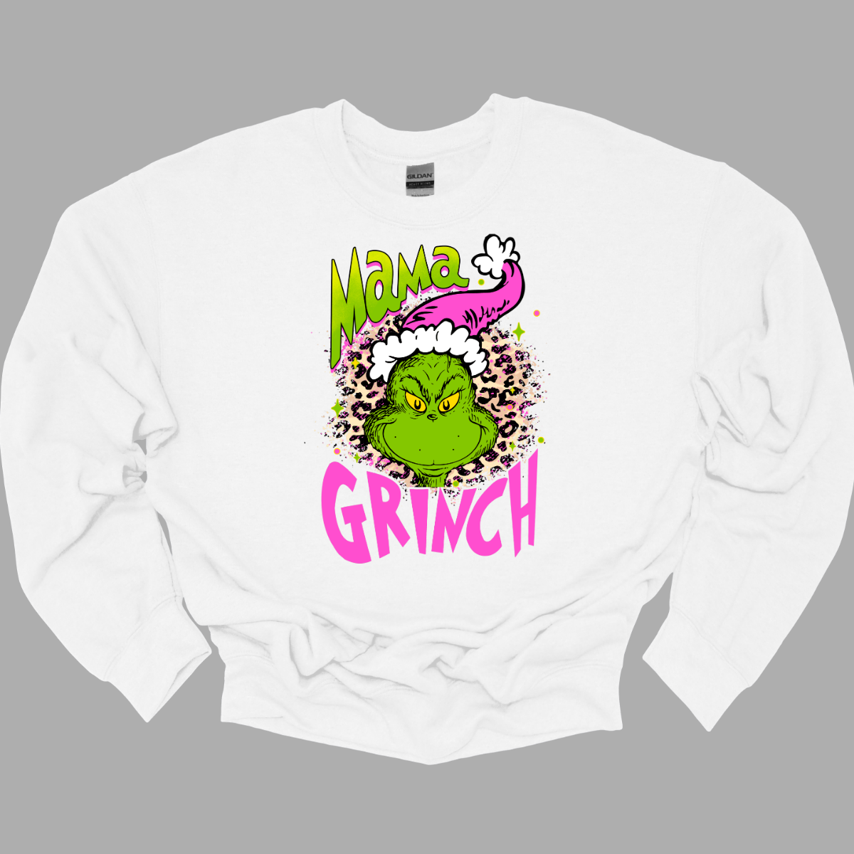 At the center of the design is the phrase "Mama Grinch," rendered in a whimsical, Grinch-style font. The word "Mama" pops in a vibrant green color with a delicate pink shadow that adds a touch of charm. The word "Grinch" contrasts in a bold, eye-catching pink that stands out against the green.&nbsp;Between the two words, there's a delightful illustration of the Grinch himself. He's sporting a cute pink and white Santa hat, which adds a fun and seasonal flair. Shop Gorgeousware.com