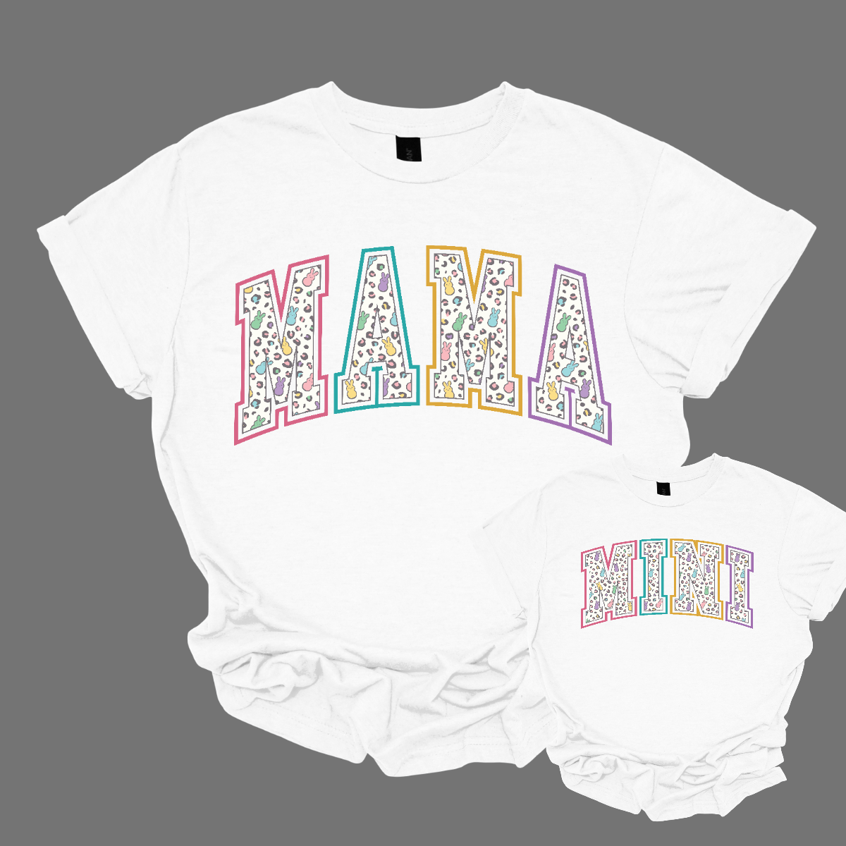 "Mama" and "Mini" Easter T-shirts - Celebrate the bond between mother and child with our charming matching set! Adorned with adorable peeps forming the words "Mama" and "Mini," these Easter-themed shirts are as sweet as can be. Whether you're hunting for eggs, enjoying a springtime picnic, or simply spending quality time together, these shirts are the perfect way to showcase your special connection. Shop at Gorgeousware.com