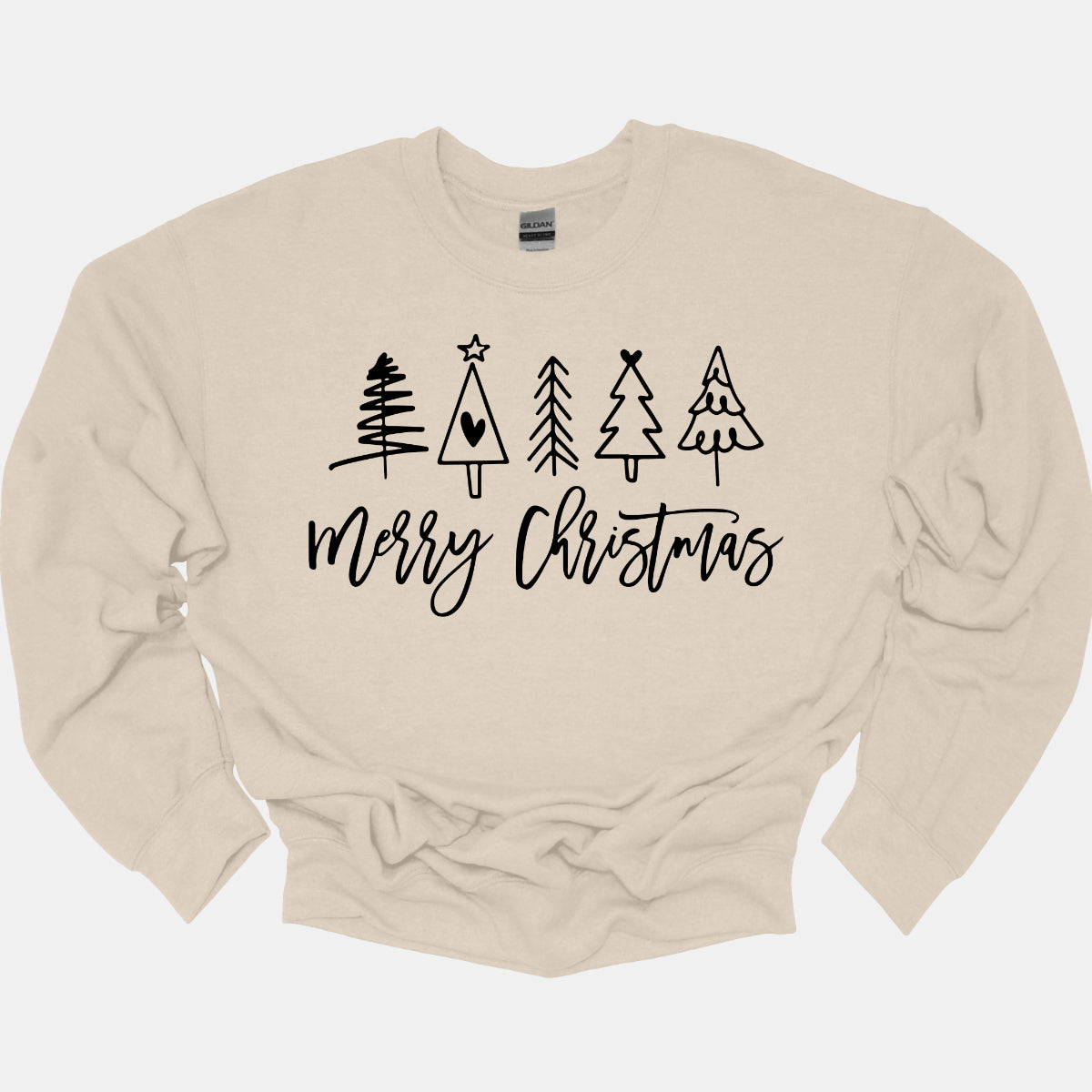 This charming t-shirt features the festive greeting "Merry Christmas" in a stylish black cursive font that flows beautifully across the front. Above the phrase, five delightful stick figure Christmas trees stand tall, each uniquely decorated to showcase its own personality. Shop Gorgeousware.com