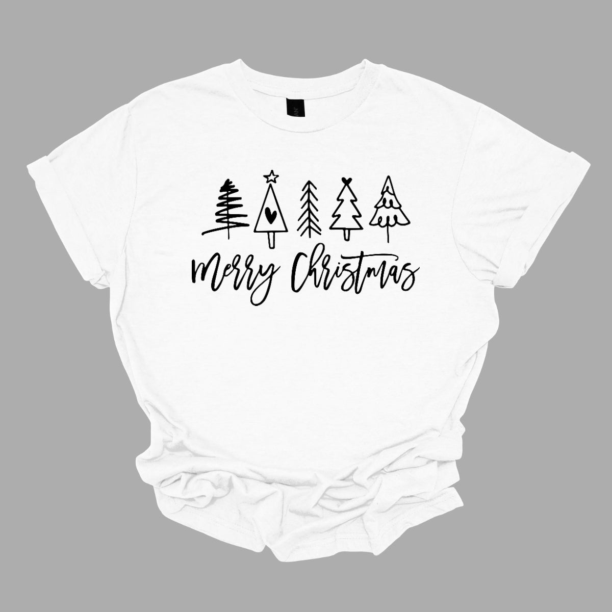 This charming t-shirt features the festive greeting "Merry Christmas" in a stylish black cursive font that flows beautifully across the front. Above the phrase, five delightful stick figure Christmas trees stand tall, each uniquely decorated to showcase its own personality. Shop Gorgeousware.com