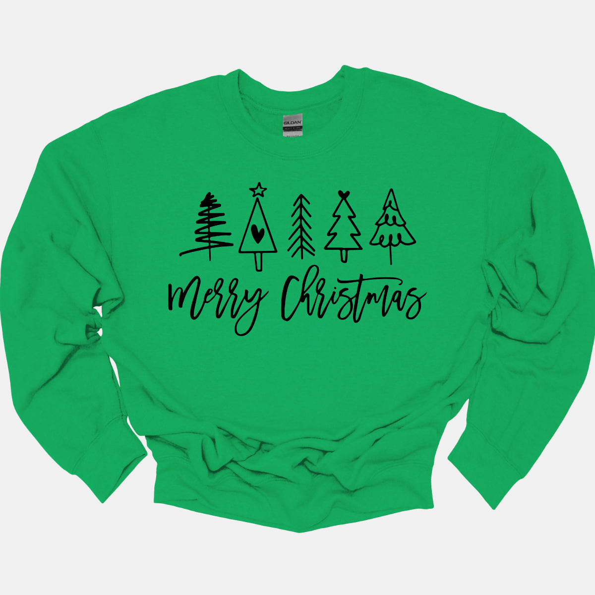 This charming t-shirt features the festive greeting "Merry Christmas" in a stylish black cursive font that flows beautifully across the front. Above the phrase, five delightful stick figure Christmas trees stand tall, each uniquely decorated to showcase its own personality. Shop Gorgeousware.com