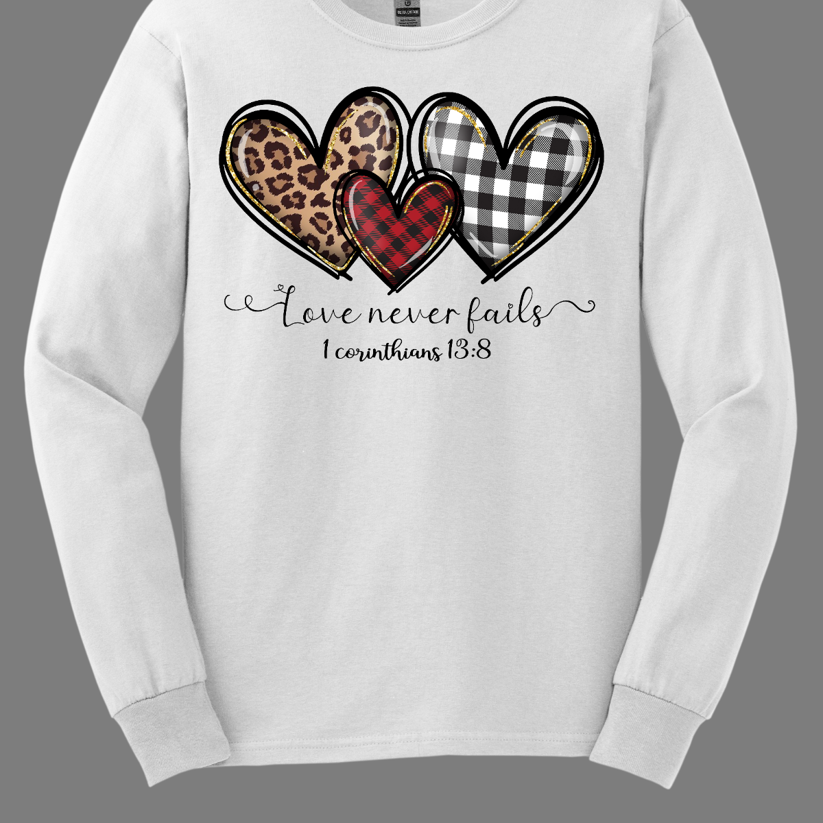 Introducing our "Love Never Fails - 1 Corinthians 13:8" T-shirt – a profound and heartwarming garment adorned with three adorable patterned hearts. This shirt carries a timeless message inspired by the scripture, emphasizing the enduring nature of love. The phrase "Love Never Fails - 1 Corinthians 13:8" is elegantly displayed, drawing inspiration from the Bible verse. Surrounding the sentiment are three cute hearts, each uniquely patterned with delightful designs. Shop at Gorgeousware.com