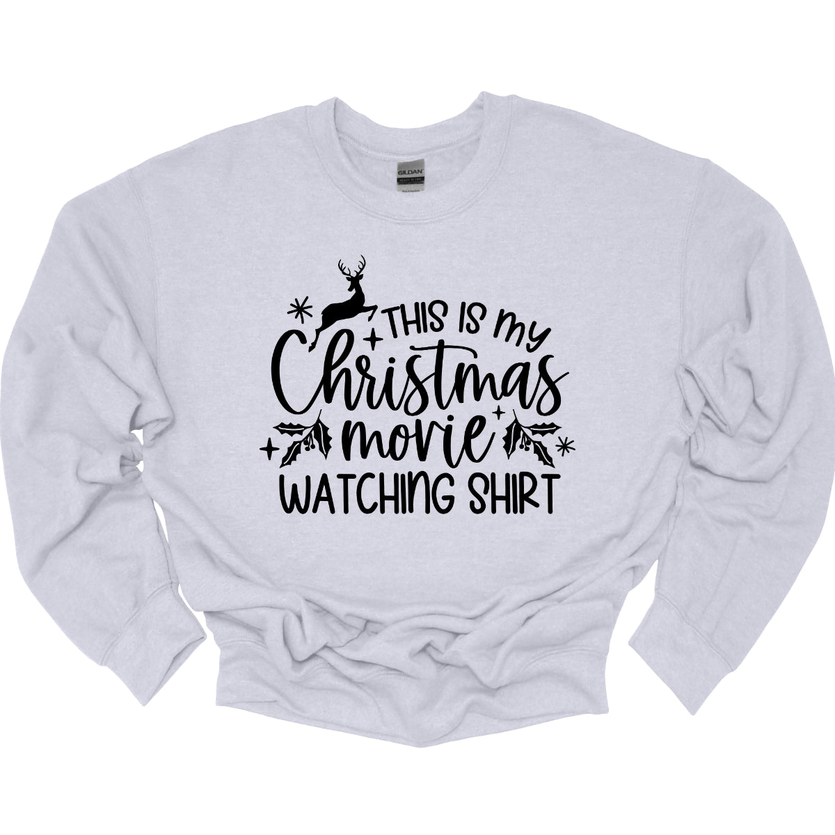 This cozy t-shirt features the playful phrase "This Is My Christmas Movie Watching Shirt" in a straightforward, easy-to-read font. The words "Christmas Movie" are beautifully highlighted in an elegant cursive font, adding a touch of festive flair. Shop Gorgeousware.com