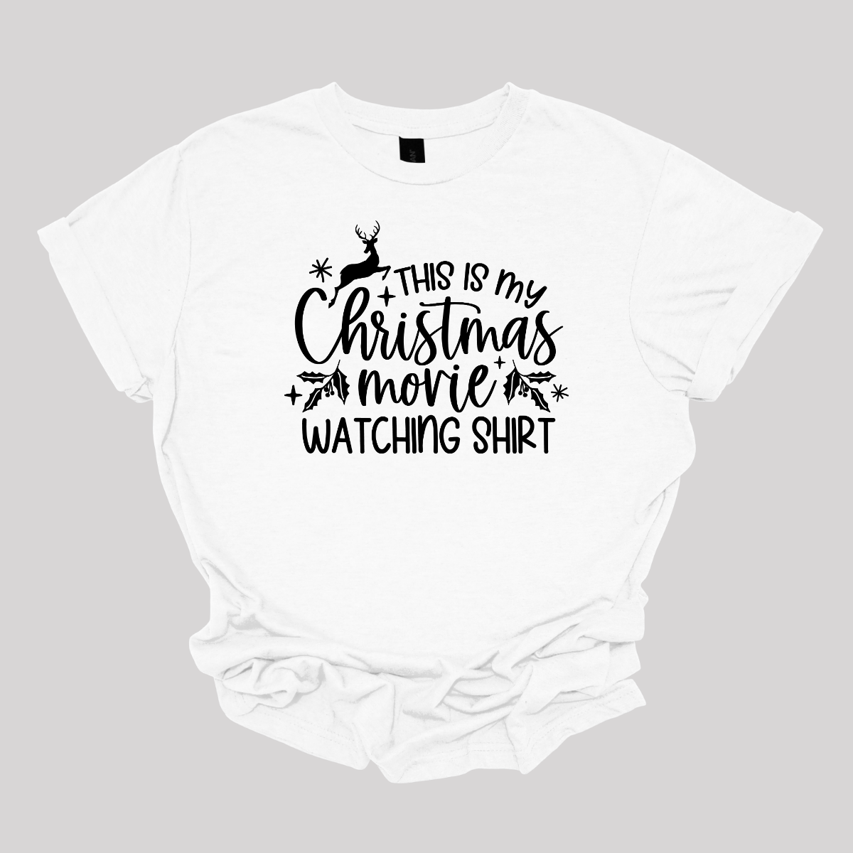 This cozy t-shirt features the playful phrase "This Is My Christmas Movie Watching Shirt" in a straightforward, easy-to-read font. The words "Christmas Movie" are beautifully highlighted in an elegant cursive font, adding a touch of festive flair. Shop Gorgeousware.com