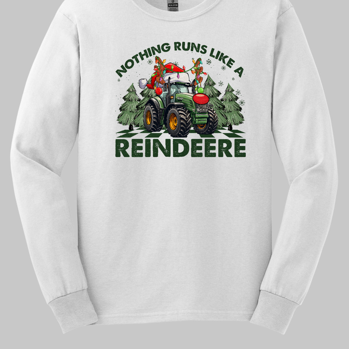 This playful t-shirt features the catchy phrase "Nothing runs like a reindeer" in bold black font, making a fun statement that’s perfect for the holiday season. At the center of the shirt, a charming John Deere tractor is decked out for Christmas: it sports a bright red nose, festive antlers, and a classic Santa hat, creating a delightful and humorous twist.&nbsp;The tractor is surrounded by whimsical Christmas trees, adding a cheerful backdrop that enhances the festive vibe. Shop Gorgeousware.com