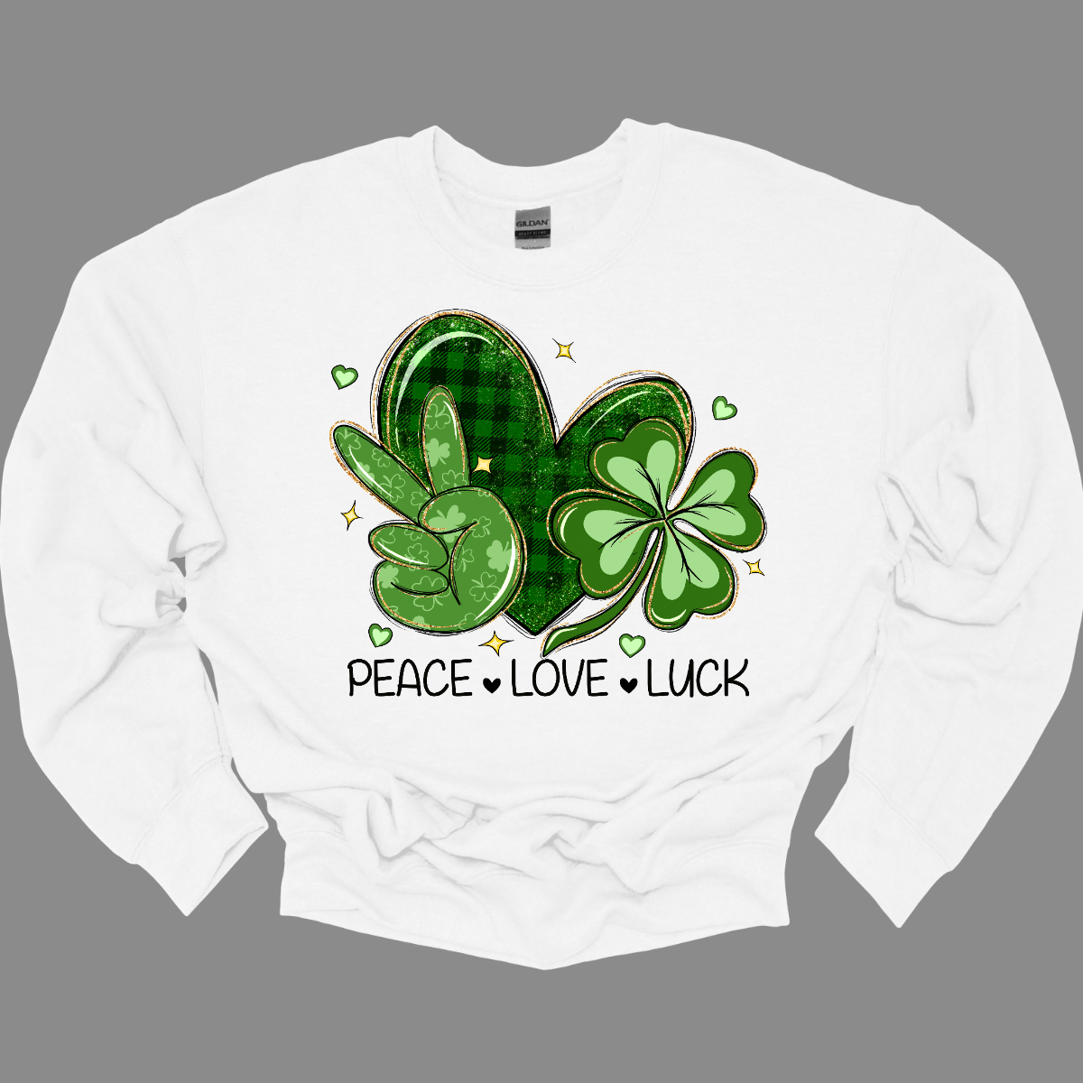 Get ready to spread the vibes of peace, love, and luck this St. Patrick's Day with our vibrant design! Featuring a hand adorned with the universal peace sign in lush green, a heart embellished with classic black and green plaid, and a two-toned green shamrock, this illustration embodies the essence of the holiday. Let's celebrate with joy and unity, embracing the spirit of St. Patrick's Day! Shop at Gorgeousware.com today!