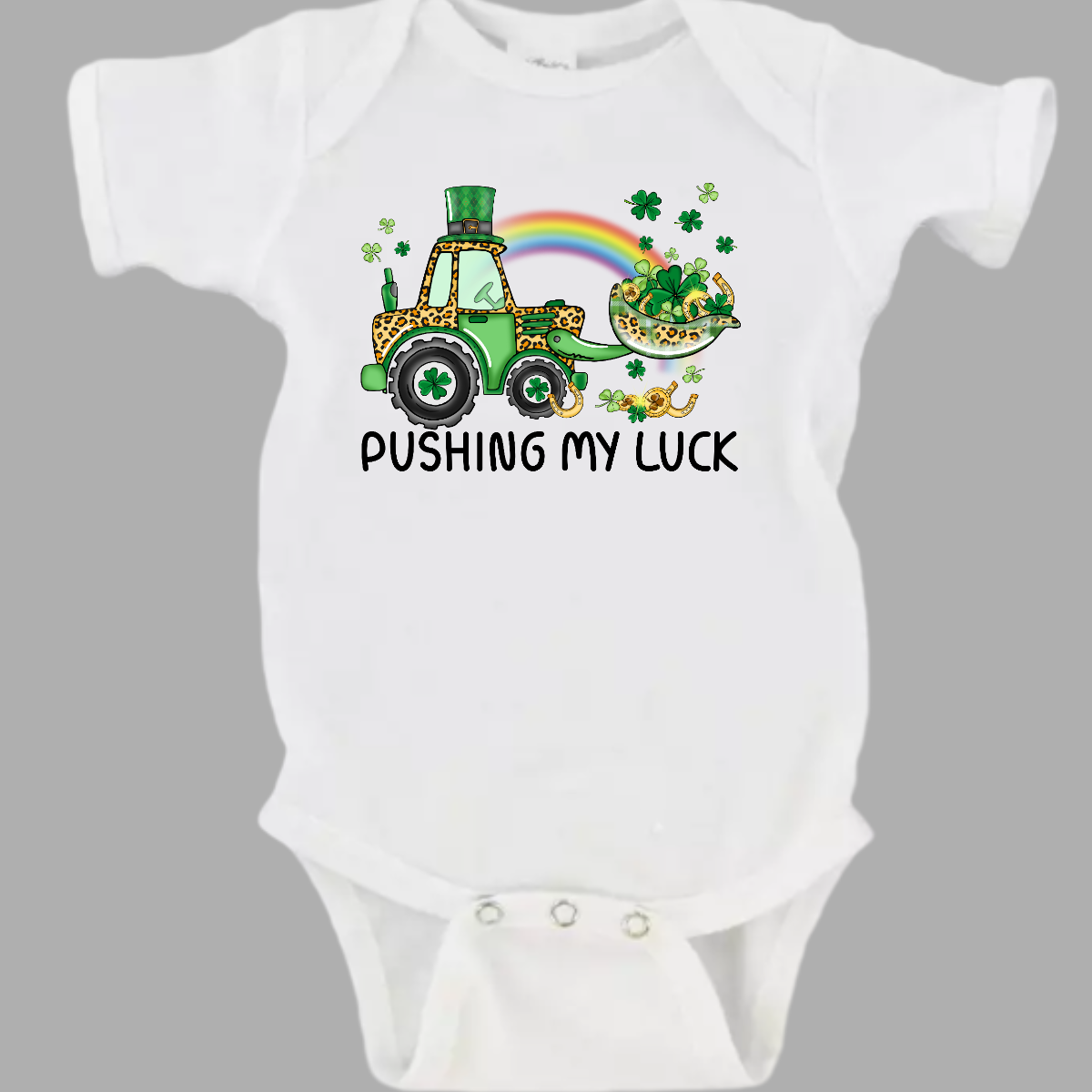 A playful and whimsical garment that captures the spirit of the holiday with a touch of fun. This shirt features a lively design with a tractor playfully shoveling a load of shamrocks, creating a unique and charming representation of pushing one's luck in a St. Patrick's Day context. The design showcases a tractor adorned with shamrocks, symbolizing the act of "pushing" luck in a light-hearted and festive manner. Shop at Gorgeousware.com