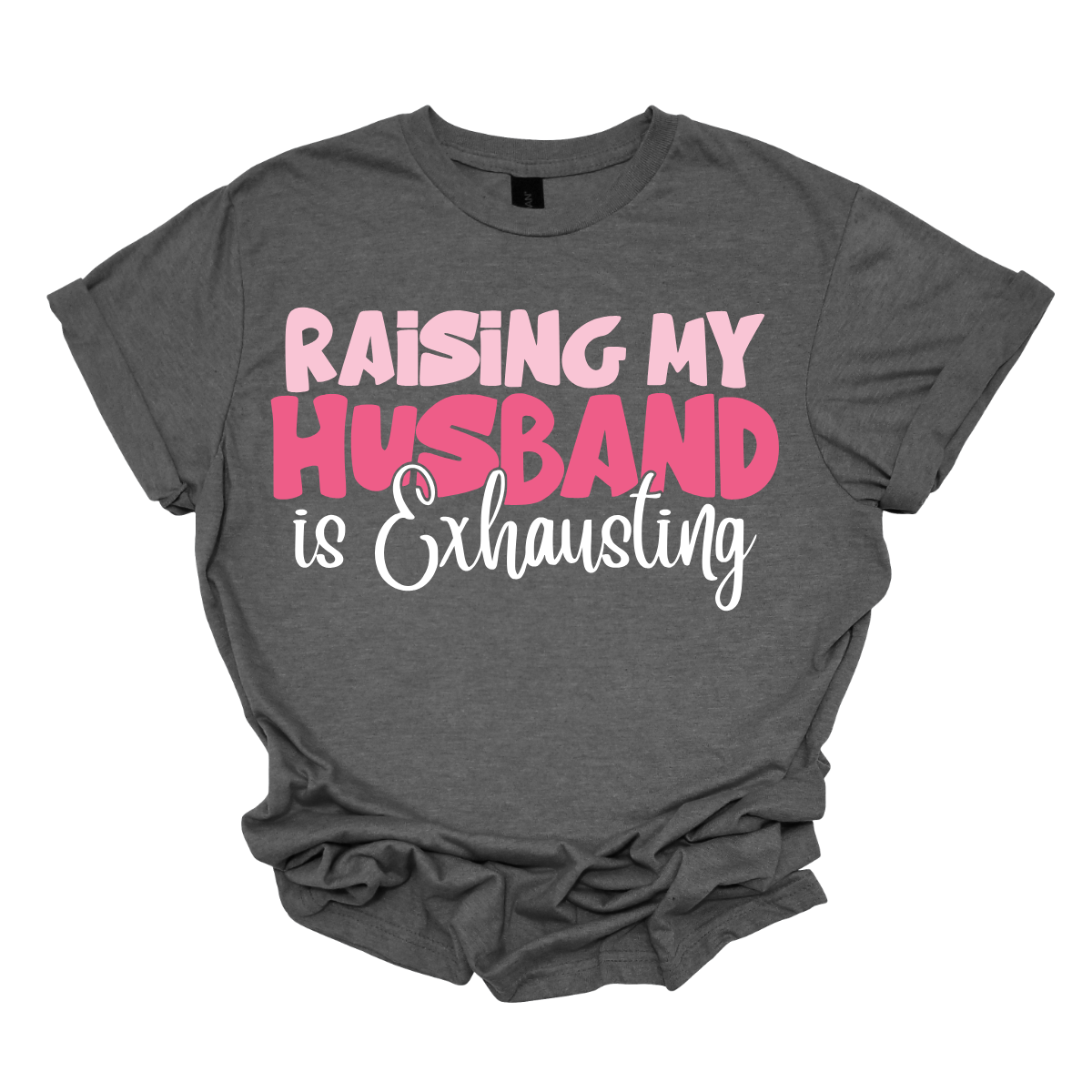 This T-shirt features the humorous phrase "Raising My Husband Is Exhausting" prominently across the chest. The text is creatively arranged in a mix of playful and quirky fonts, each each line standing out with a unique style. The color palette is a soft and vibrant pink, with a varying shade to enhance the fun and lighthearted vibe of the design.  Shop at Gorgeousware.com