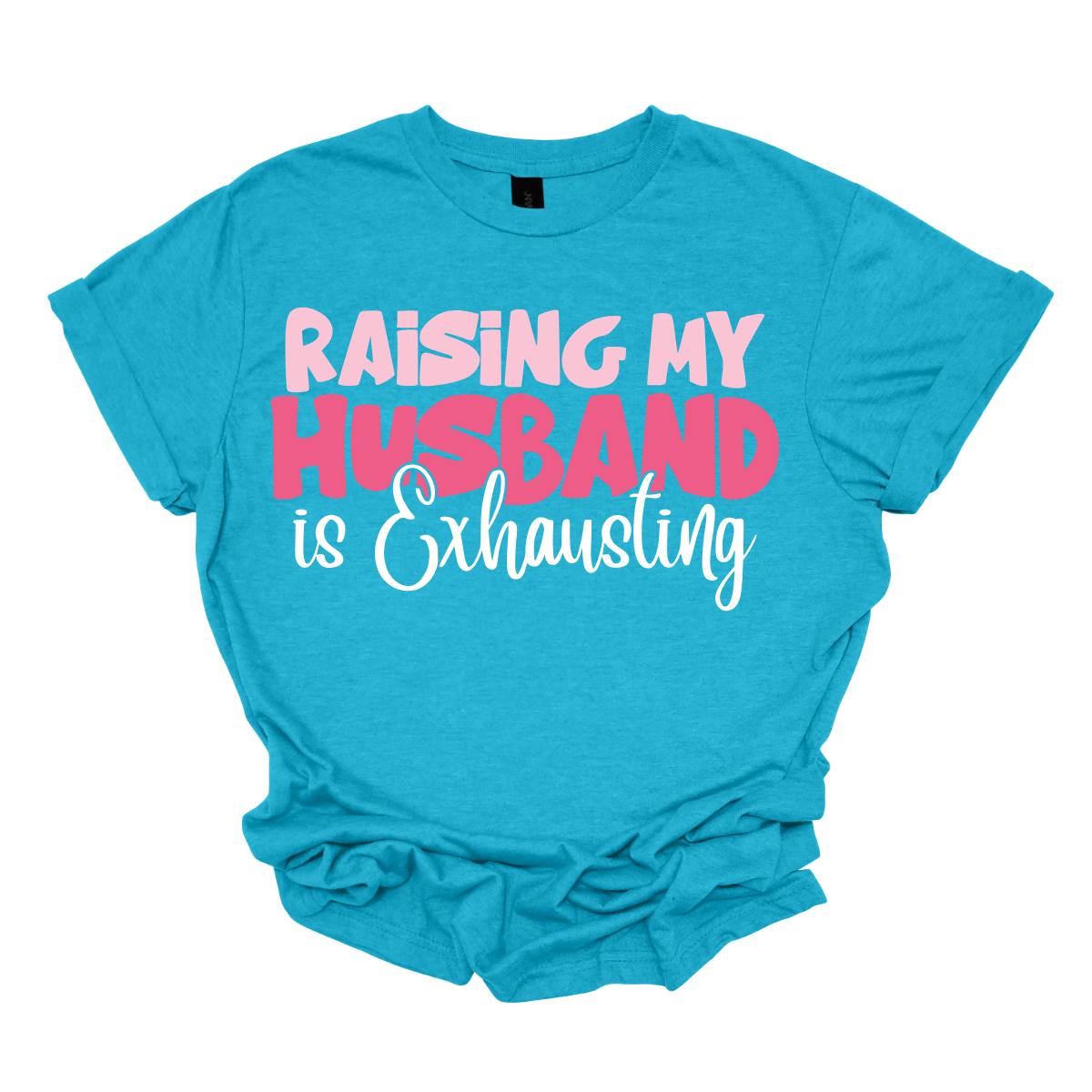 This T-shirt features the humorous phrase "Raising My Husband Is Exhausting" prominently across the chest. The text is creatively arranged in a mix of playful and quirky fonts, each each line standing out with a unique style. The color palette is a soft and vibrant pink, with a varying shade to enhance the fun and lighthearted vibe of the design.  Shop at Gorgeousware.com