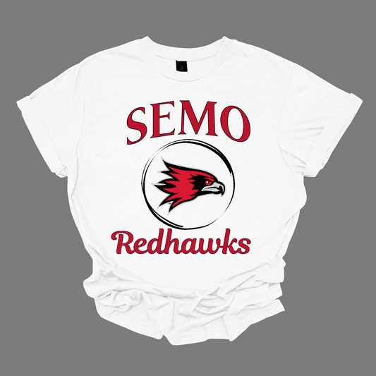 This sleek and spirited apparel is perfect for showing off school pride in a stylish way! The design starts with the bold word "Semo", representing your school or alma mater. In the center of the design, there's a circle that houses the iconic Redhawk logo, instantly recognizable and full of school spirit. At the bottom of the circle, the word "Redhawks" is elegantly scripted in a flowing cursive font, adding a touch of sophistication to the bold, athletic look. Shop at Gorgeousware.com