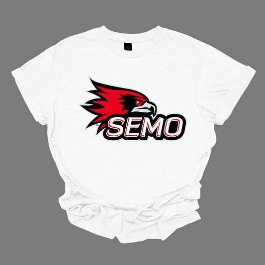The apparel design for SEMO (Southeast Missouri State University) features the bold and iconic SEMO Redhawk logo prominently displayed across the chest or front. The Redhawk logo typically showcases a fierce red hawk in mid-flight or in a dynamic, stylized form, using shades of red, black, and white. Below this powerful symbol, the word "SEMO" is written in the university's signature font, often in all capital letters. Shop at Gorgeousware.com