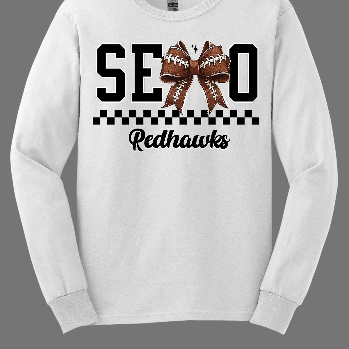 Gear up your Redhawk fan with our stylish youth SEMO apparel, available in short/ long sleeve, crewneck, and hoodie options! Featuring bold black SEMO lettering with a creative twist—the letter M is playfully replaced by a croquette football bow, adding a fun, sporty vibe. A sleek checkerboard underline ties the look together, while "Redhawks" is written in a stylish cursive script for the perfect finishing touch.
Shop at Gorgeousware.com today!

