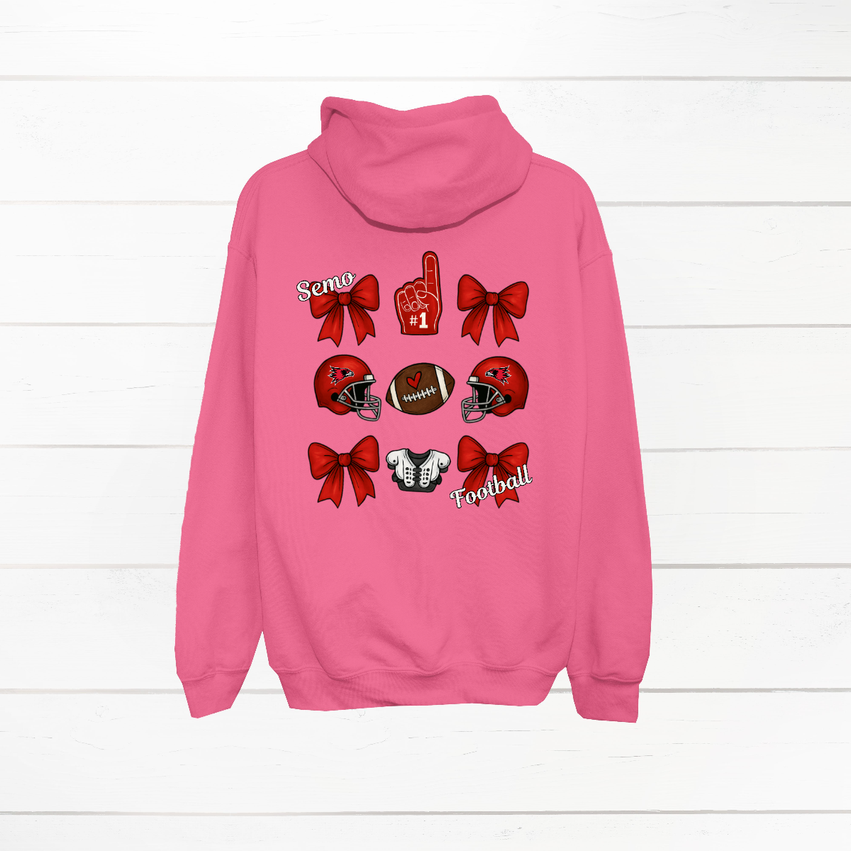 This SEMO Football Bow Grid design is available in youth sizes across short sleeve, long sleeve, crewneck, and hoodie options.
Front Design: A chic red croquette bow sits on the upper left chest, accented with bold white “SEMO” lettering.
Back Design: A playful grid layout showcases an exciting mix of Redhawk game-day icons—red croquette bows, SEMO football helmets, sturdy shoulder pads, and the classic #1 foam hand—all celebrating SEMO’s winning spirit.
Shop at Gorgeousware.com today!
