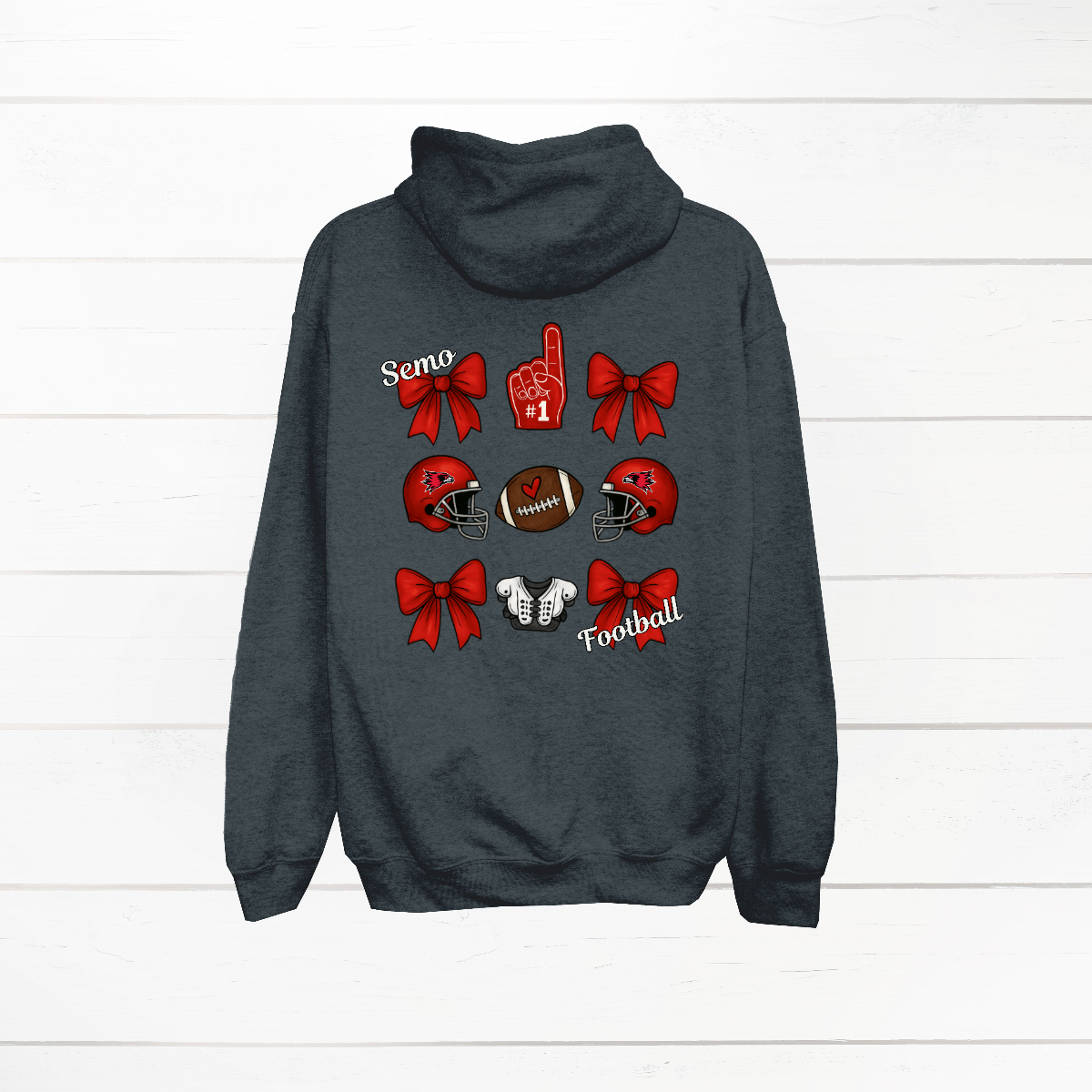 This SEMO Football Bow Grid design is available in youth sizes across short sleeve, long sleeve, crewneck, and hoodie options.
Front Design: A chic red croquette bow sits on the upper left chest, accented with bold white “SEMO” lettering.
Back Design: A playful grid layout showcases an exciting mix of Redhawk game-day icons—red croquette bows, SEMO football helmets, sturdy shoulder pads, and the classic #1 foam hand—all celebrating SEMO’s winning spirit.
Shop at Gorgeousware.com today!
