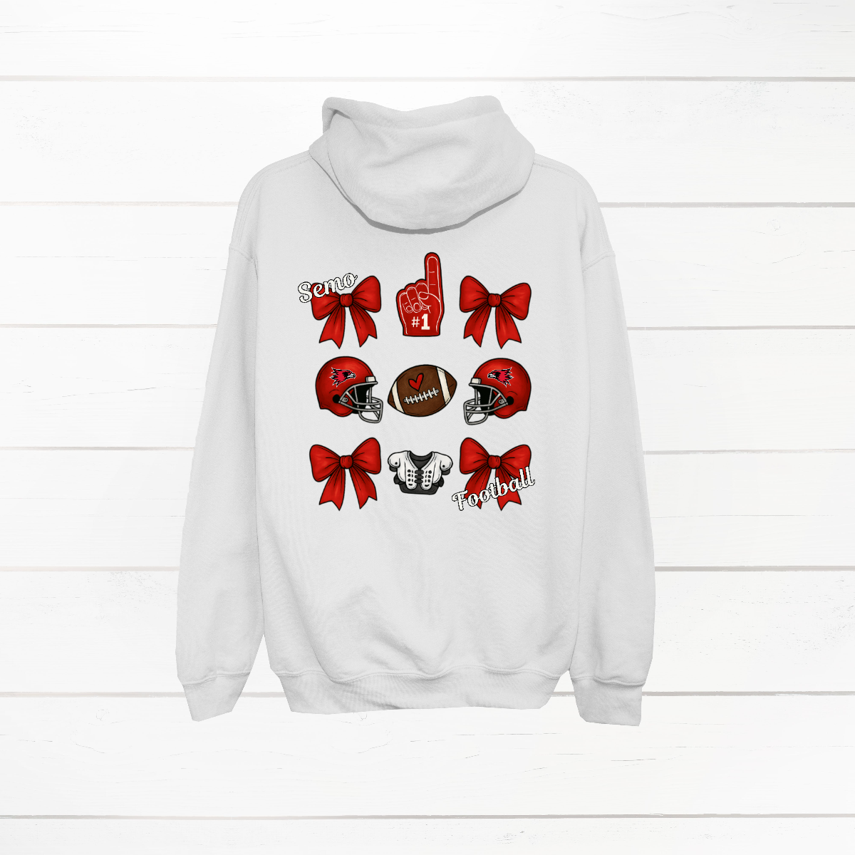 This SEMO Football Bow Grid design is available in youth sizes across short sleeve, long sleeve, crewneck, and hoodie options.
Front Design: A chic red croquette bow sits on the upper left chest, accented with bold white “SEMO” lettering.
Back Design: A playful grid layout showcases an exciting mix of Redhawk game-day icons—red croquette bows, SEMO football helmets, sturdy shoulder pads, and the classic #1 foam hand—all celebrating SEMO’s winning spirit.
Shop at Gorgeousware.com today!
