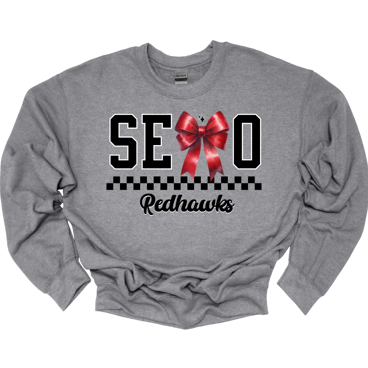 Show off your SEMO pride in style with this trendy short/long sleeve t-shirt! Featuring the bold letters "SEMO," where the "M" is cleverly replaced by a stylish red croquette bow, this shirt adds a unique twist to your wardrobe. Underneath, a playful checkerboard stripe adds a fun touch, while "Redhawks" is elegantly written in a cute cursive font, bringing a touch of flair. Get ready to turn heads and express your school spirit! Shop at Gorgeousware.com