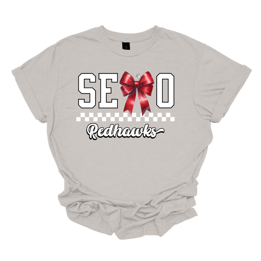 This SEMO short sleeve shirt features white lettering outlined in black with a creative twist - the letter "M" is a stylish red bow for a pop of color and school spirit. A classic checkerboard line runs through the center for a trendy, eye-catching look, while the design is completed with "Redhawks" in script underneath for the perfect final touch.
Shop at Gorgeousware.com today!
