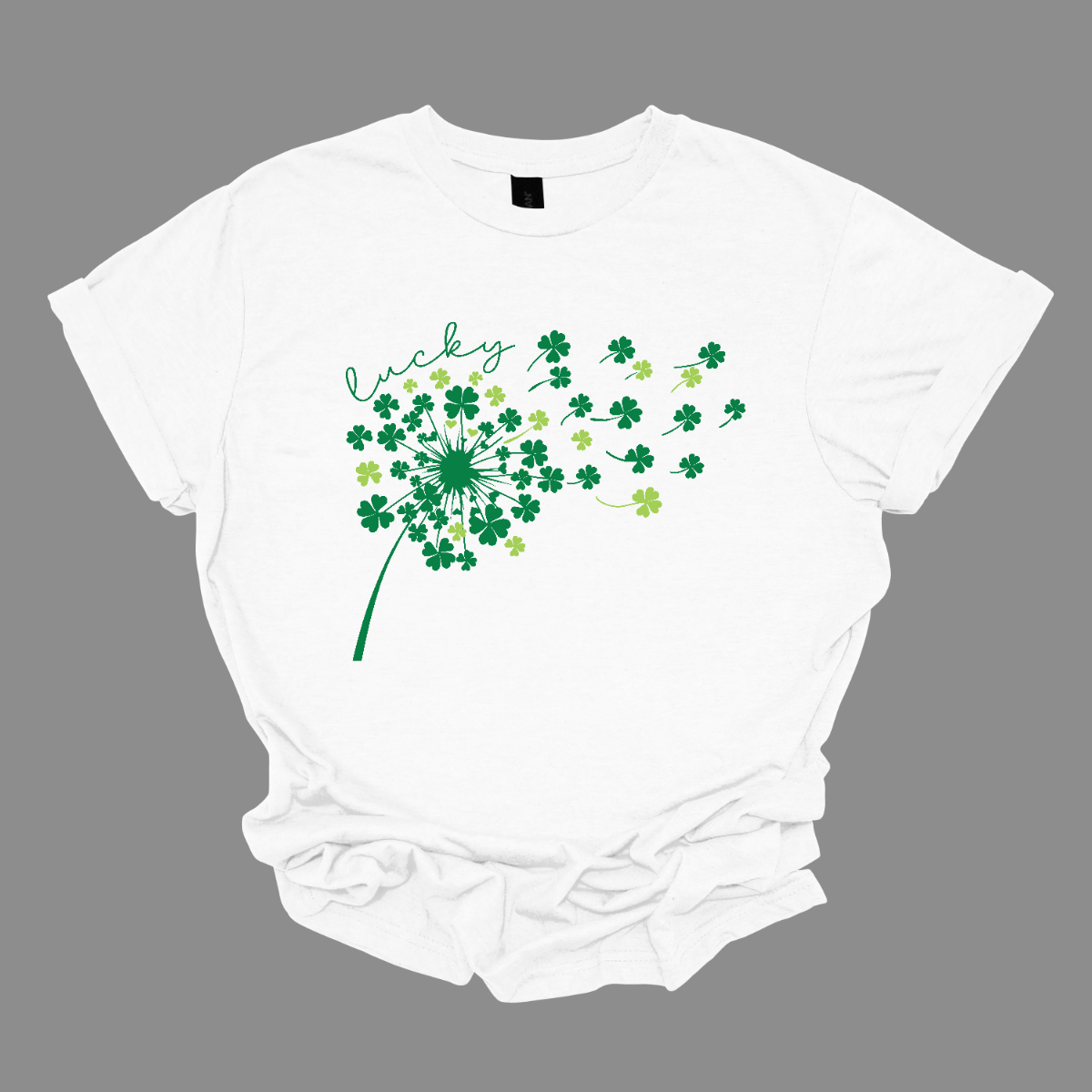 This St. Patrick's Day t-shirt features a beautiful dandelion design made entirely of shamrocks, with the petals gently blowing in the wind. Each shamrock petal comes in various shades of green, creating a dynamic, nature-inspired look. The wind carries the shamrocks delicately across the design, evoking a sense of freedom and luck. The design is both whimsical and festive, perfect for celebrating the season. Celebrate in style this St. Patrick's Day with this charming design, available at Gorgeousware.com.