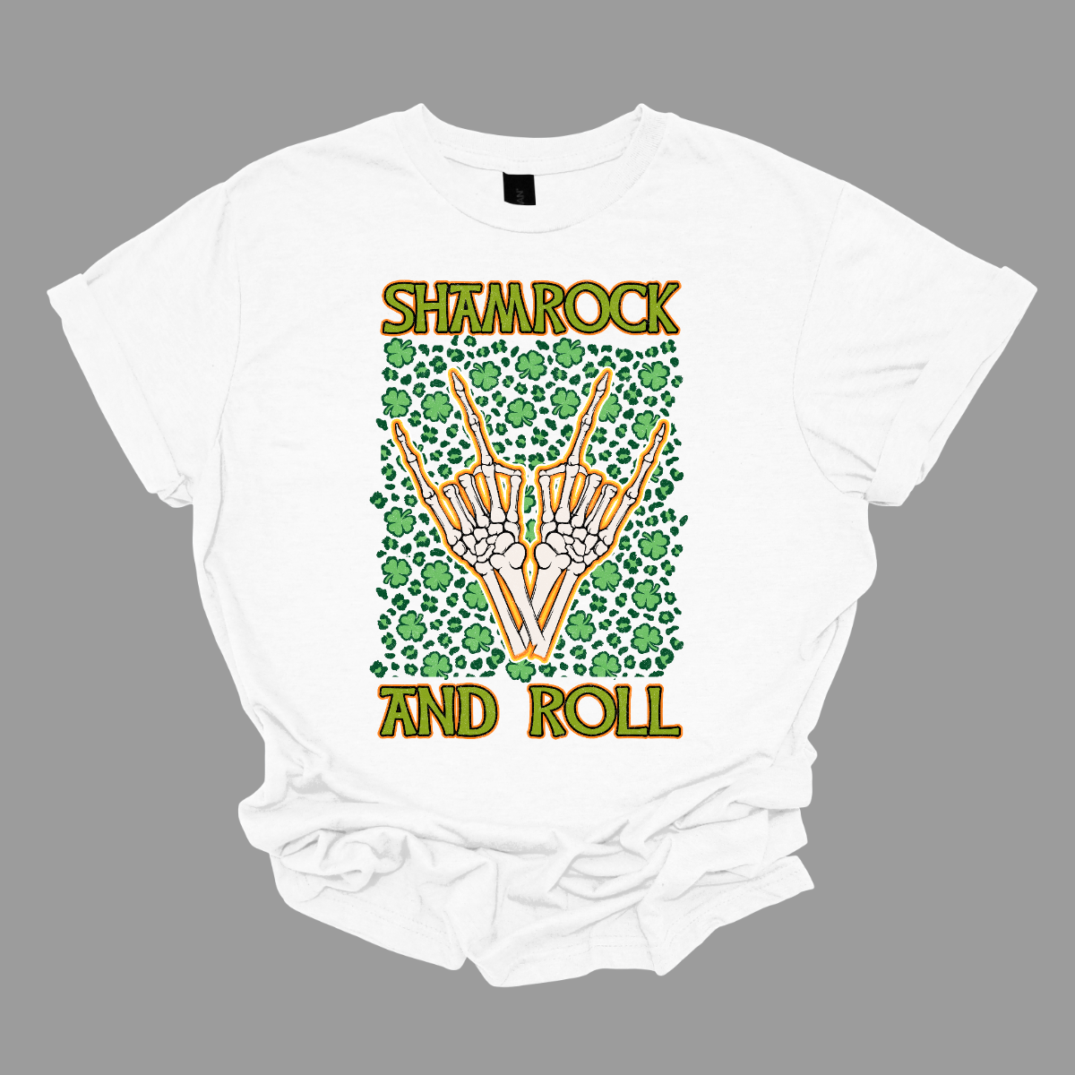 Introducing our "Shamrock and Roll" T-shirt – a unique and edgy garment that combines the spirit of St. Patrick's Day with a rock 'n' roll twist. This shirt features a dynamic design with skeleton fingers rocking out amidst a backdrop of vibrant shamrocks, creating a visually striking and energetic representation of the theme. Shop at Gorgeousware.com