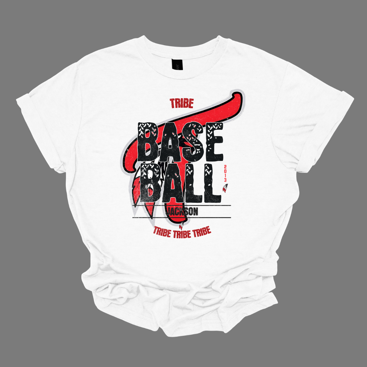 Imagine a vintage-inspired graphic tee with an old-school vibe. The shirt features a small red print of the word "Tribe" at the top, capturing a nostalgic essence. In the background, there's a large, eye-catching Tribe logo, rendered in a distressed style that adds character. Over this logo, the word "Baseball" is prominently displayed in a bold, textured font, evoking a sense of classic athleticism. Shop at Gorgeousware.com