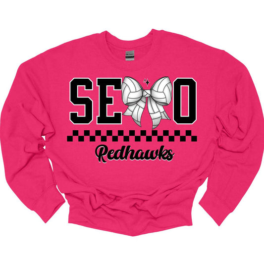 The apparel design features the word "SEMO" in a bold collegiate font, with a unique twist on the letter "M." Instead of the standard "M," a bow with a volleyball pattern is used, making it a distinctive and sporty element. Beneath "SEMO," a striking black checkerboard pattern runs horizontally across the garment, adding visual contrast and energy. hop at Gorgeousware.com