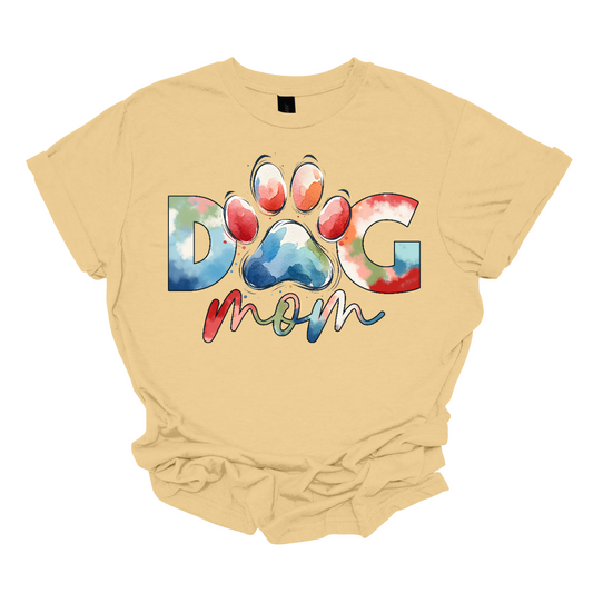Imagine a stylish and vibrant "Dog Mom" shirt featuring bold, block letters filled with a tie-dye pattern. The letters have a groovy, retro vibe, with swirling shades of blue, pink, red, and orange, giving it a fun and playful energy.  The o" is a paw print.  Shop Gorgeousware.com