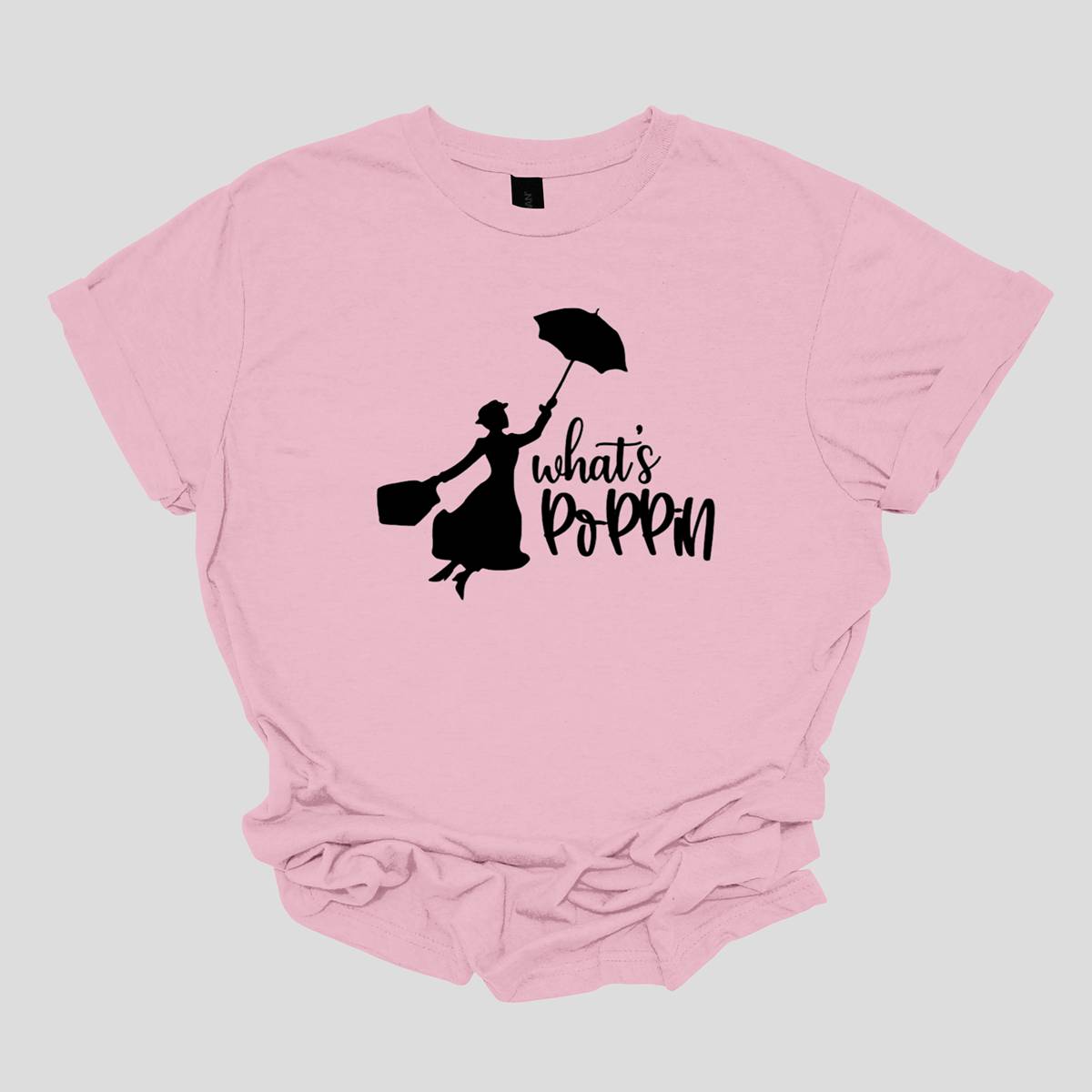 This t-shirt features a chic and playful design with the phrase "What's Poppin'" rendered in an elegant black cursive font. The flowing script adds a touch of sophistication and style to the design. Next to the text is a silhouette of Mary Poppins, capturing the iconic character's classic charm and whimsical essence. The silhouette showcases Mary Poppins with her signature umbrella and carpet bag, adding a delightful and nostalgic touch to the shirt. Shop Gorgeousware.com