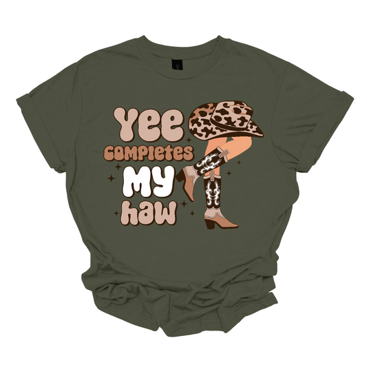  Introducing our "Yee Completes My Haw" T-shirt – a playful and charming garment that adds a touch of Western humor to your wardrobe. This shirt features the phrase "Yee Completes My Haw" accompanied by a whimsical illustration of a cowgirl leg kicked back, adorned with boots and a hat. Shop at Gorgesouware.com