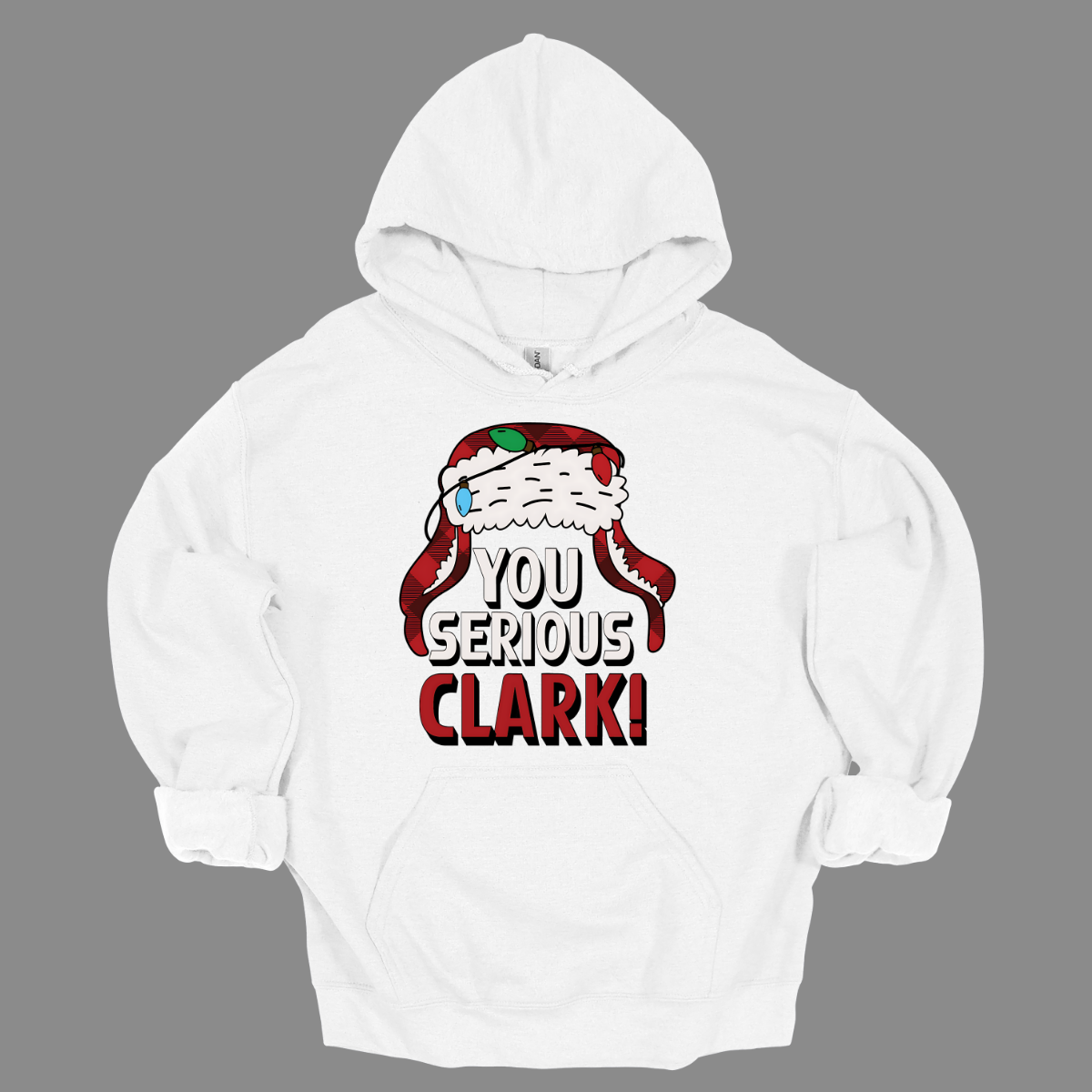 Get ready to light up the holiday season with a dose of classic comedy! Our “You Serious, Clark!” t-shirt pays homage to the unforgettable line from National Lampoon’s Christmas Vacation. Featuring a bold, eye-catching graphic of Clark Griswold’s iconic winter trapper hat, adorned with colorful Christmas lights, this shirt is perfect for any fan of the movie. Shop at Gorgeousware.com