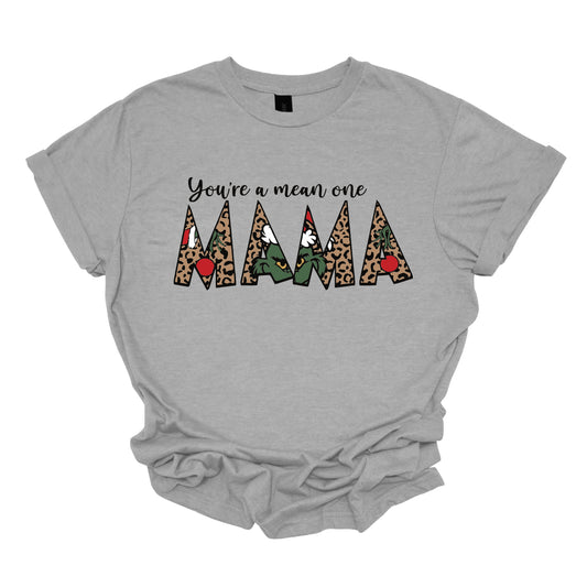  The phrase "You're a Mean One Mama" takes center stage, with "You're a Mean One" written in elegant black cursive font that flows beautifully across the fabric.&nbsp;The standout element is the word "Mama," which is rendered in bold, eye-catching letters. Each letter of "Mama" is filled with a quirky depiction of the Grinch, set against a vibrant cheetah print background. Shop Gorgeousware.com